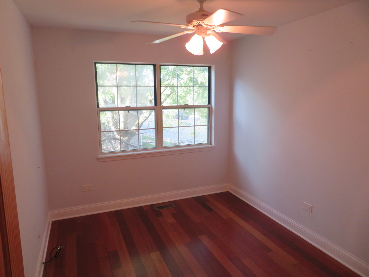 457 North Cambridge Drive, Unit 457 Palatine, IL 60067 - Photo 20 of 31 wooden floor in an empty room with a window