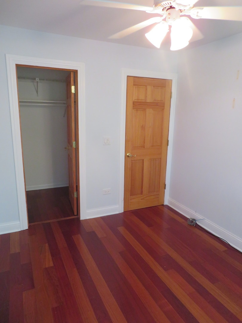 457 North Cambridge Drive, Unit 457 Palatine, IL 60067 - Photo 23 of 31 a view of an empty room with wooden floor