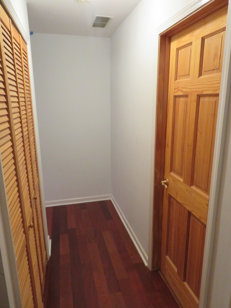457 North Cambridge Drive, Unit 457 Palatine, IL 60067 - Photo 26 of 31 an empty room with wooden floor and windows