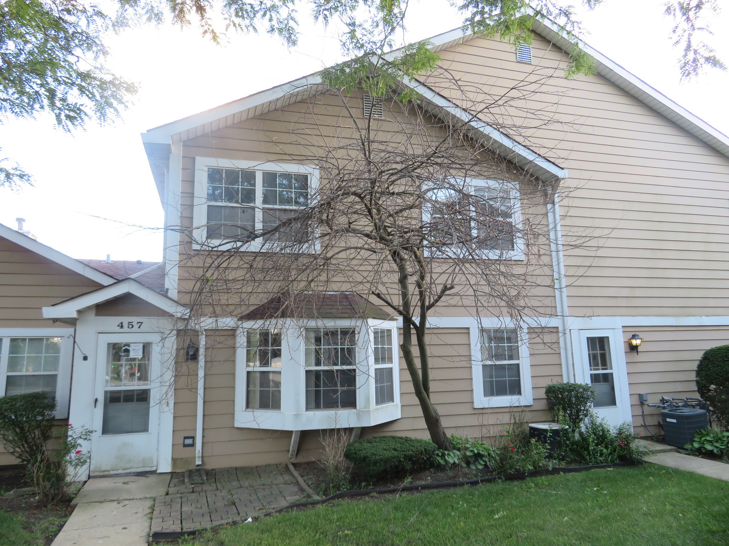 457 North Cambridge Drive, Unit 457 Palatine, IL 60067 - Photo 31 of 31 a view of a white house next to a yard