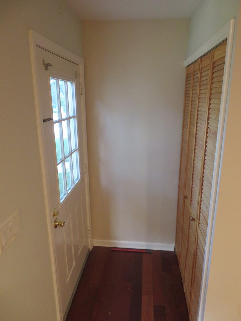 457 North Cambridge Drive, Unit 457 Palatine, IL 60067 - Photo 4 of 31 a view of a room with wooden floor and windows