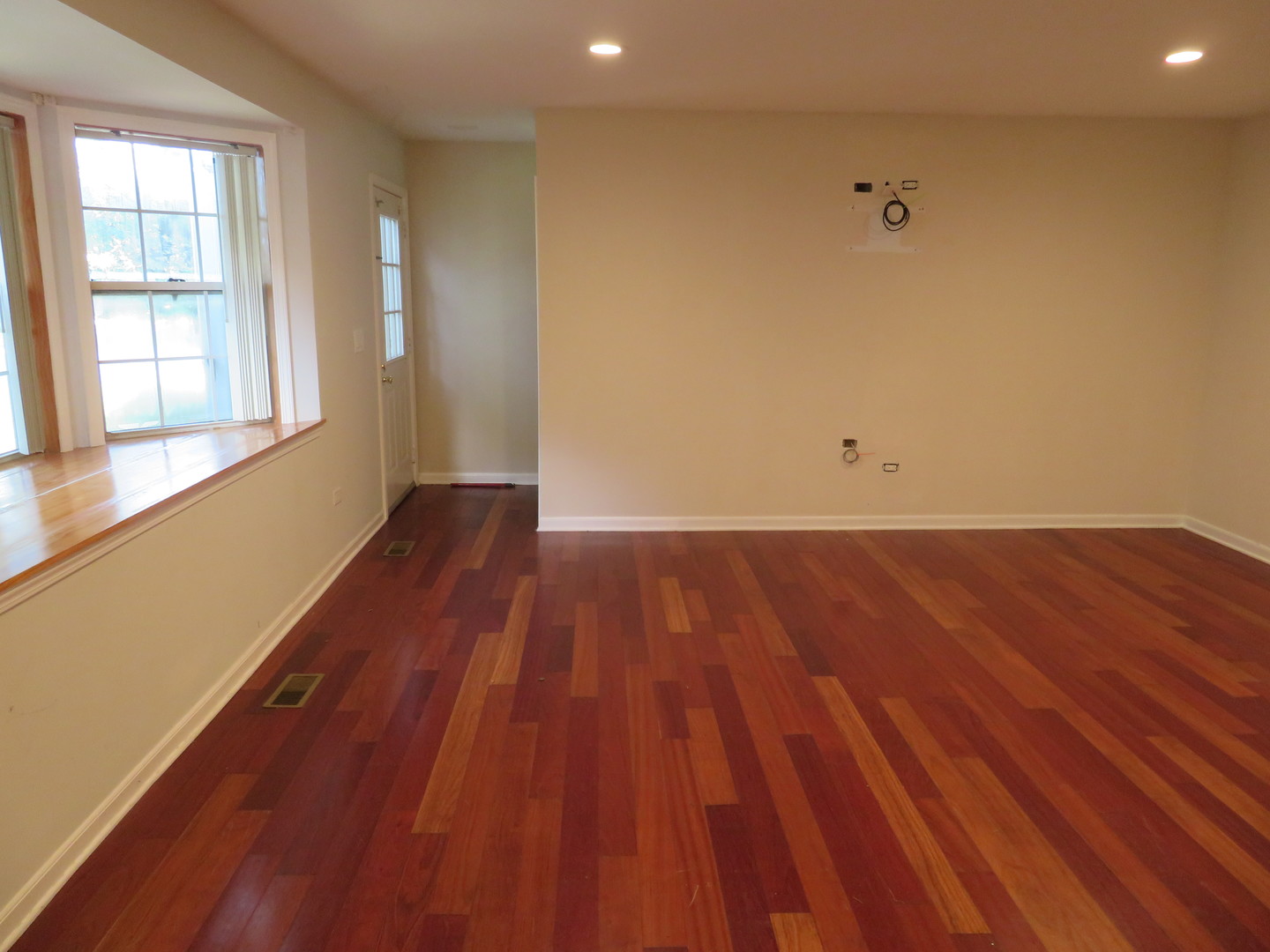 457 North Cambridge Drive, Unit 457 Palatine, IL 60067 - Photo 5 of 31 a view of a room with wooden floor and white walls