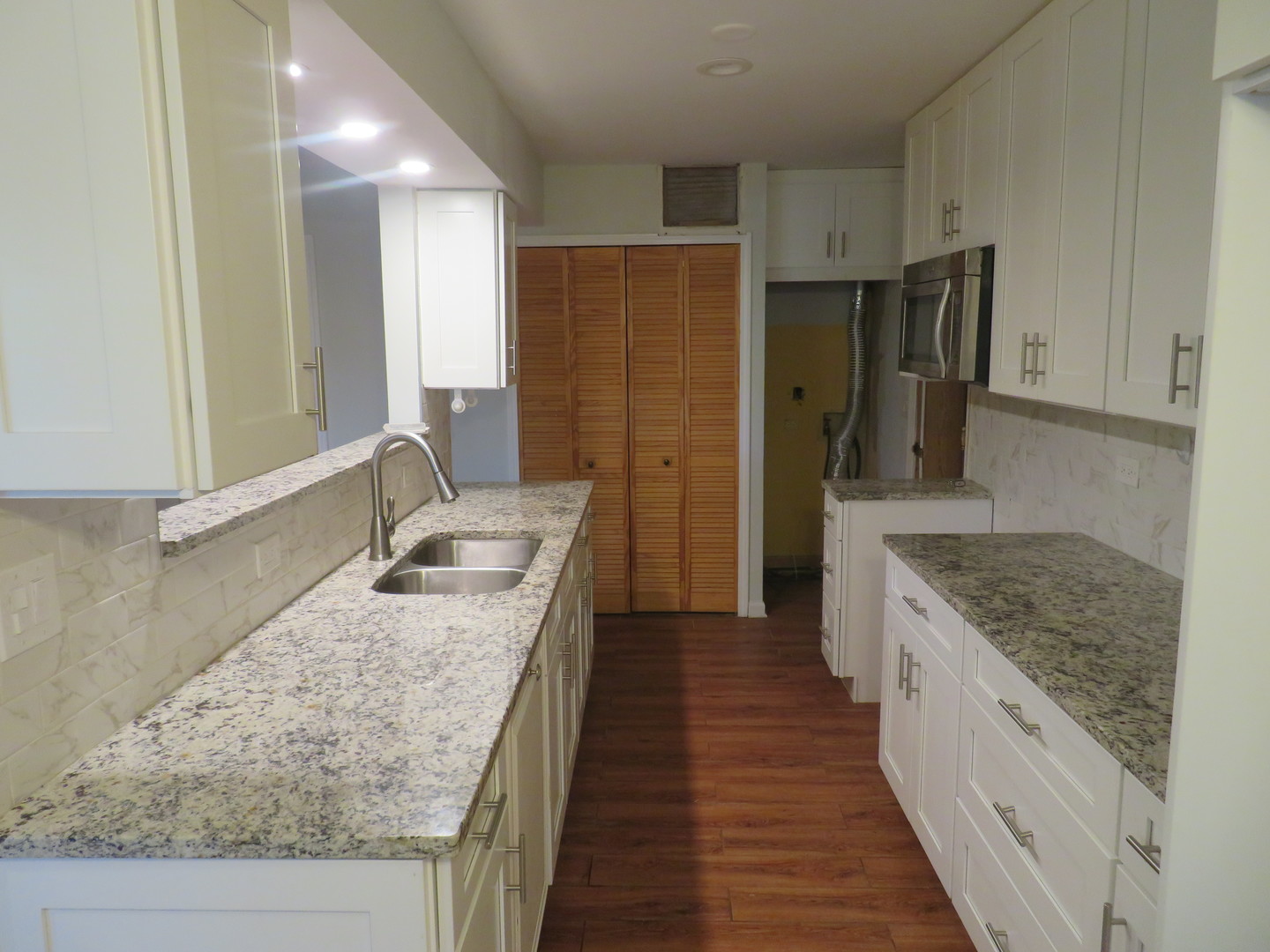 457 North Cambridge Drive, Unit 457 Palatine, IL 60067 - Photo 9 of 31 a large kitchen with granite countertop a sink and refrigerator