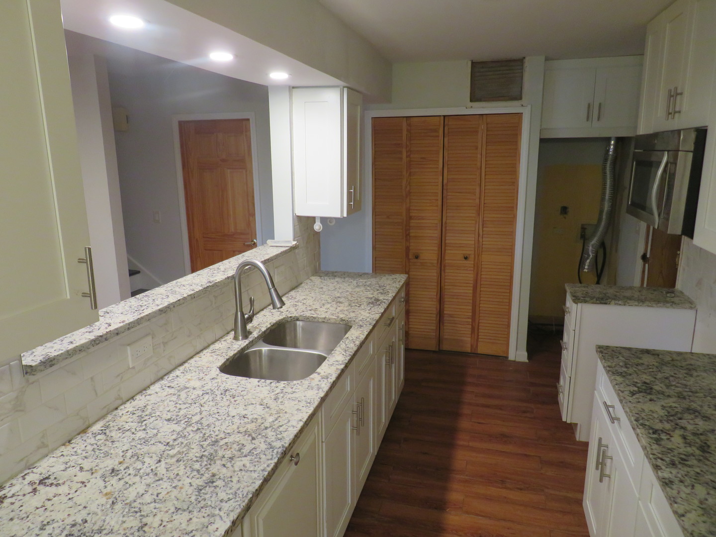457 North Cambridge Drive, Unit 457 Palatine, IL 60067 - Photo 10 of 31 a kitchen with a sink and refrigerator