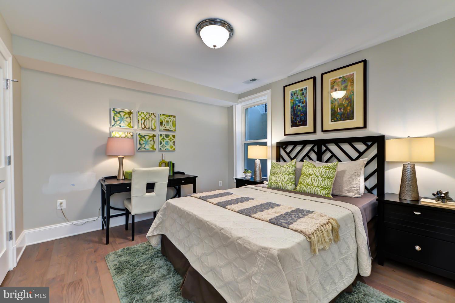 3921 Fulton Street Northwest, Unit 1 Washington, DC 20007 - Photo 11 of 25 a bedroom with a bed and wooden floor