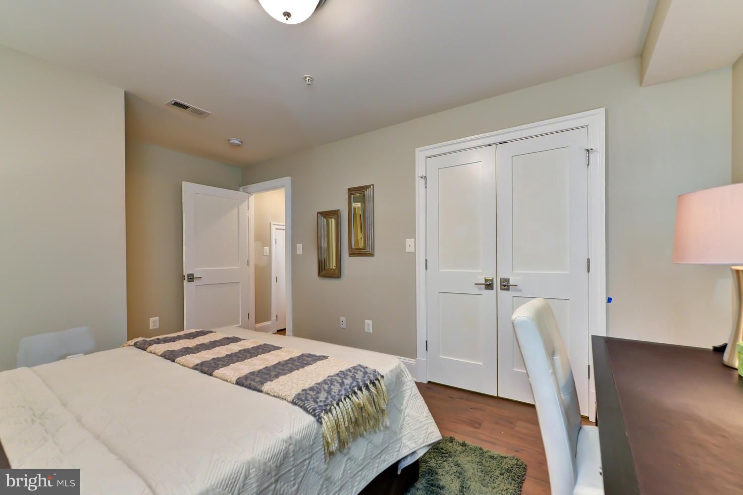 3921 Fulton Street Northwest, Unit 1 Washington, DC 20007 - Photo 13 of 25 a bedroom with a bed and wooden floor