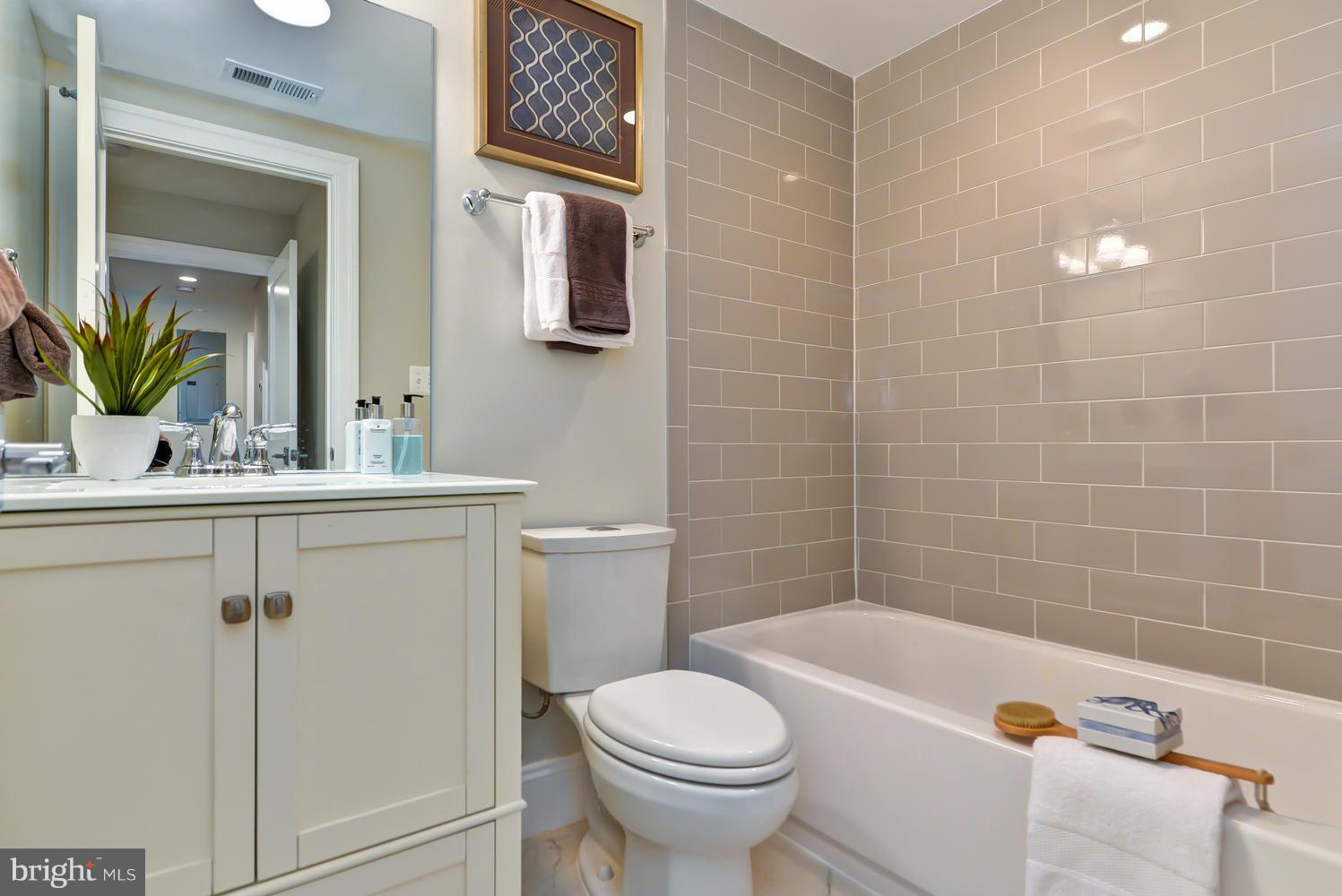 3921 Fulton Street Northwest, Unit 1 Washington, DC 20007 - Photo 17 of 25 a bathroom with a sink a toilet and bathtub