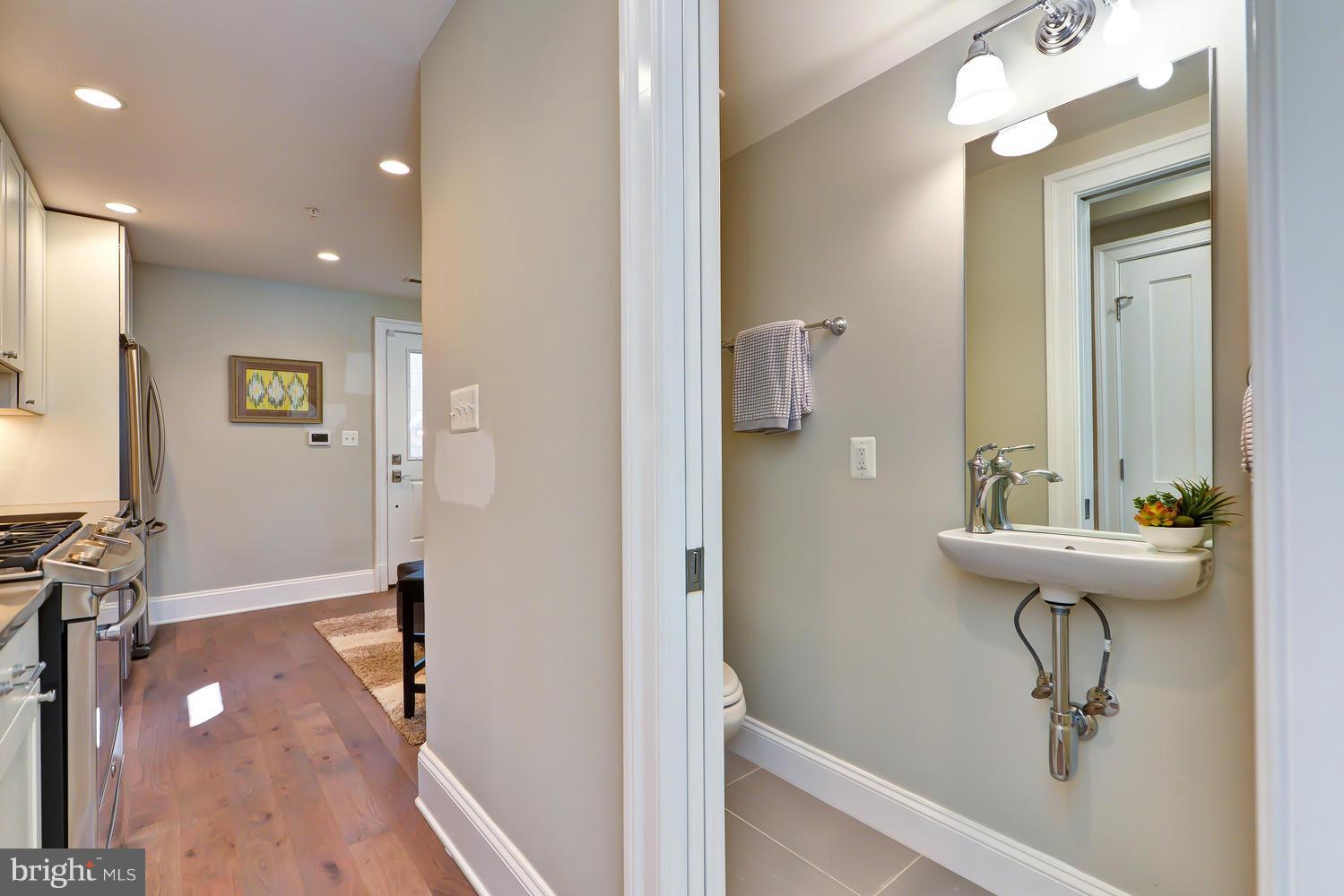 3921 Fulton Street Northwest, Unit 1 Washington, DC 20007 - Photo 9 of 25 a view of a bathroom with a sink mirror and shower