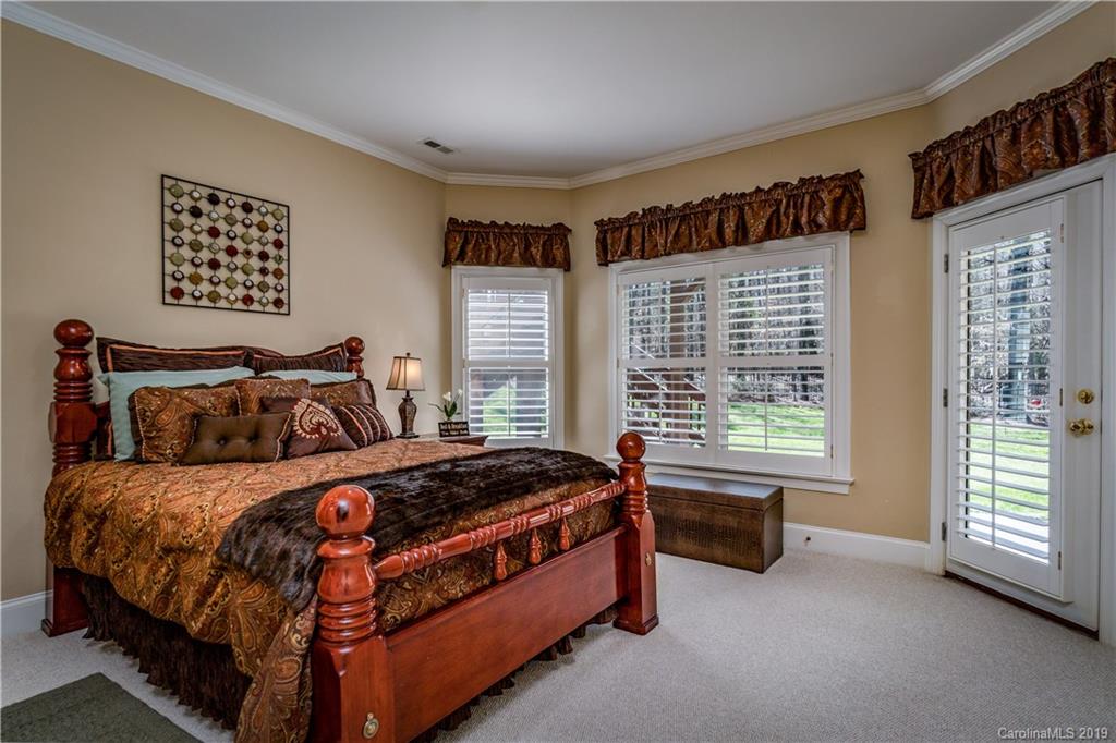 3116 Rhett Butler Place Charlotte, NC 28270 - Photo 12 of 18 a bedroom with a bed and a large window