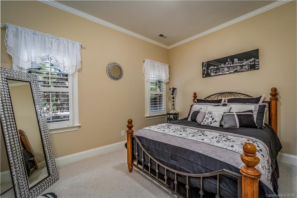 3116 Rhett Butler Place Charlotte, NC 28270 - Photo 13 of 18 a bedroom with a bed a dresser with wooden floor