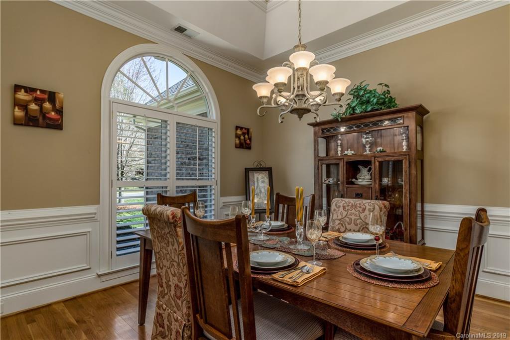 3116 Rhett Butler Place Charlotte, NC 28270 - Photo 4 of 18 a view of a dining room with furniture a chandelier and wooden floor