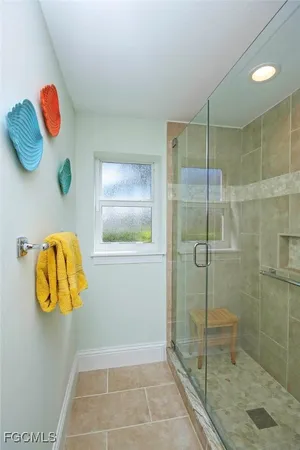 a bathroom with a shower and a mirror