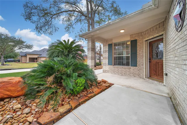 a view of a house with a yard and potted plants