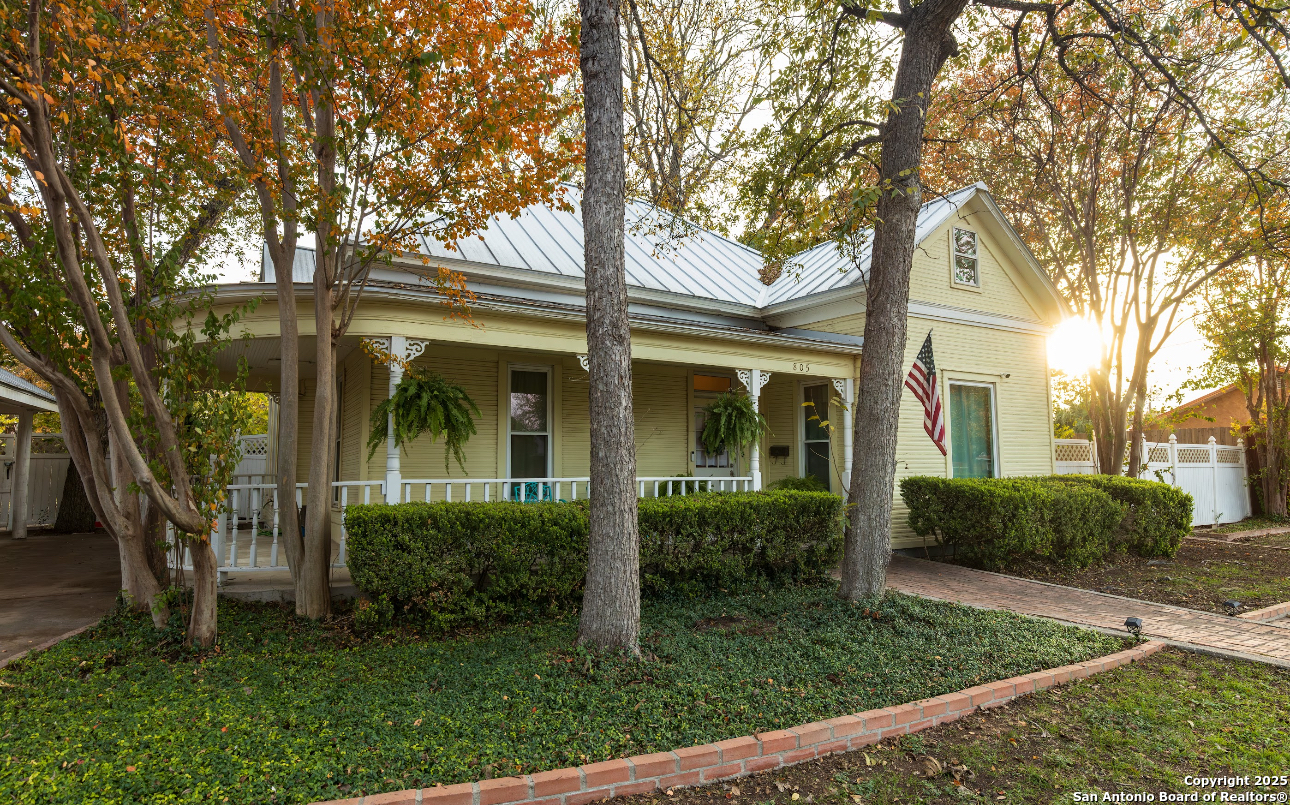 front view of a house with a tree