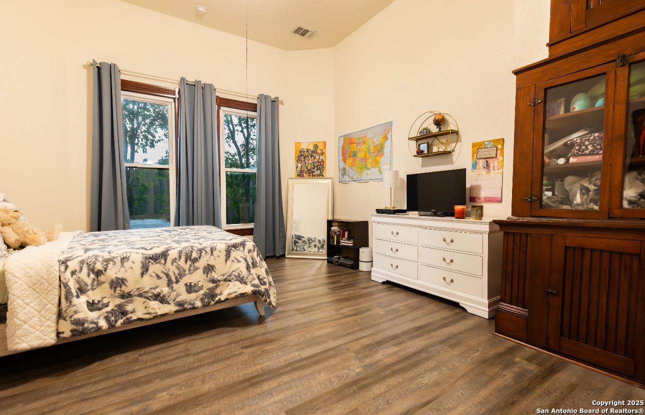 805 20th Street Hondo, TX 78861 - Photo 17 of 30 a bedroom with a bed and wooden floor