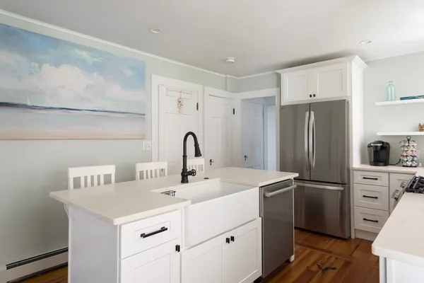 a kitchen with a sink and a refrigerator