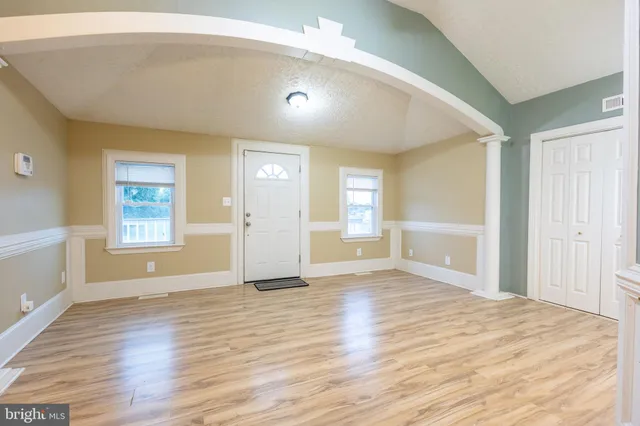 a view of a kitchen with wooden floor and a refrigerator