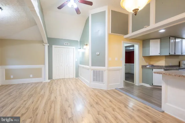 a view of empty room with wooden floor