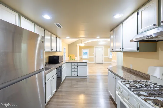 a kitchen with stainless steel appliances granite countertop a stove and a sink
