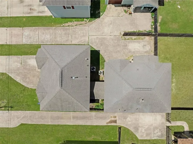 an aerial view of a house with a yard