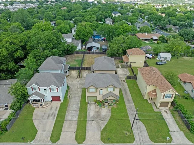 an aerial view of a house with outdoor space patio and trees all around