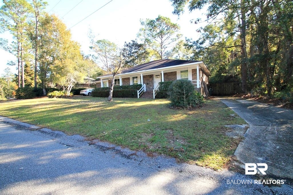 205 Montclair Loop Daphne, AL 36526 - Photo 17 of 19 View of front of house with a porch and a front lawn