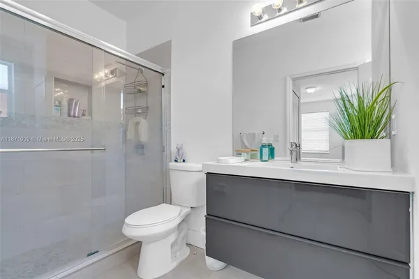 a bedroom with bed and a chandelier