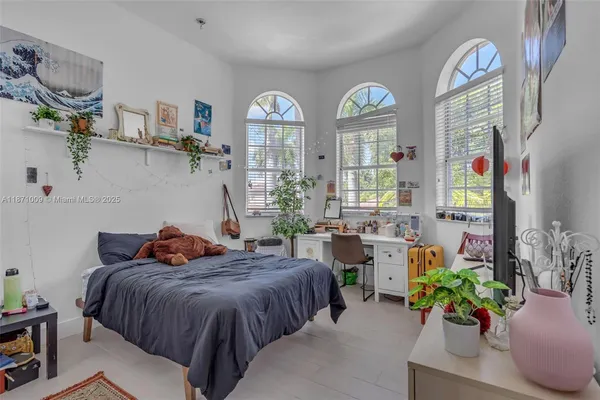 a view of a livingroom with furniture and a large window