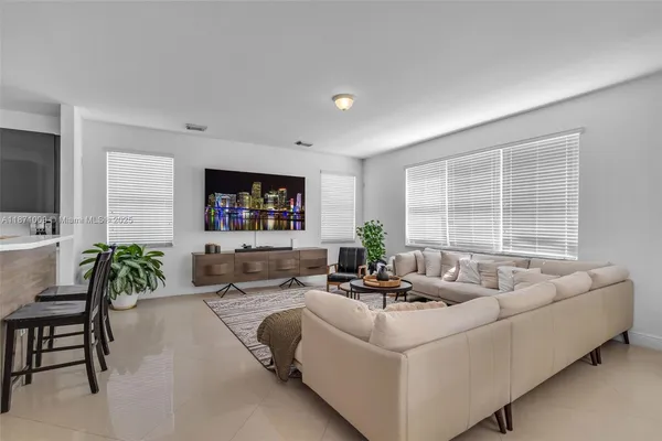 a dining room with stainless steel appliances a table and chairs in it