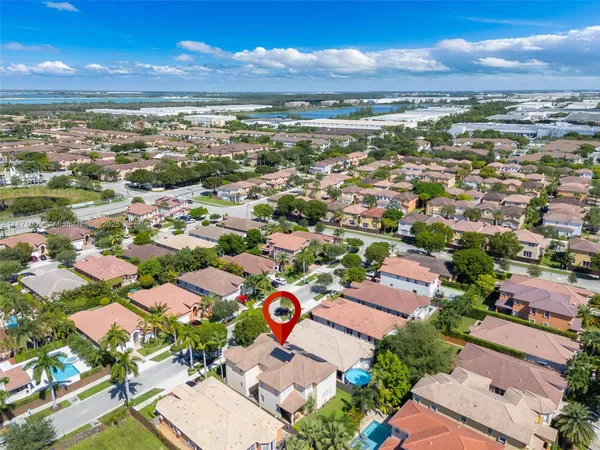 an aerial view of a city with lots of residential buildings lake and ocean view