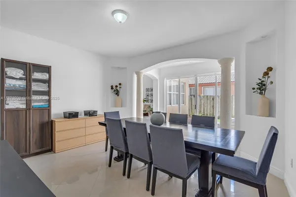 a view of a dining room with furniture and chandelier