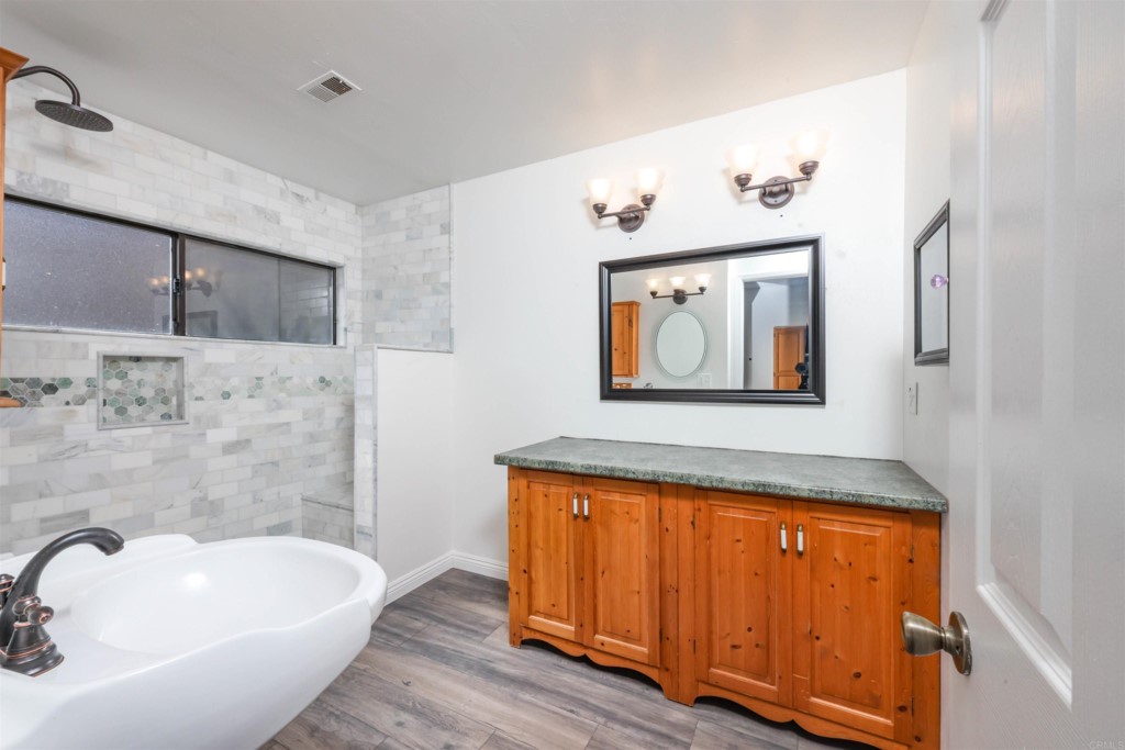 2513 Sarbonne Drive Oceanside, CA 92054 - Photo 15 of 55 a bathroom with a tub and sink