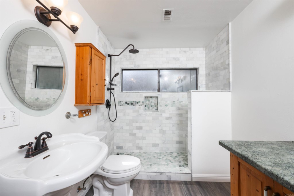 2513 Sarbonne Drive Oceanside, CA 92054 - Photo 16 of 55 a bathroom with a sink a toilet and shower