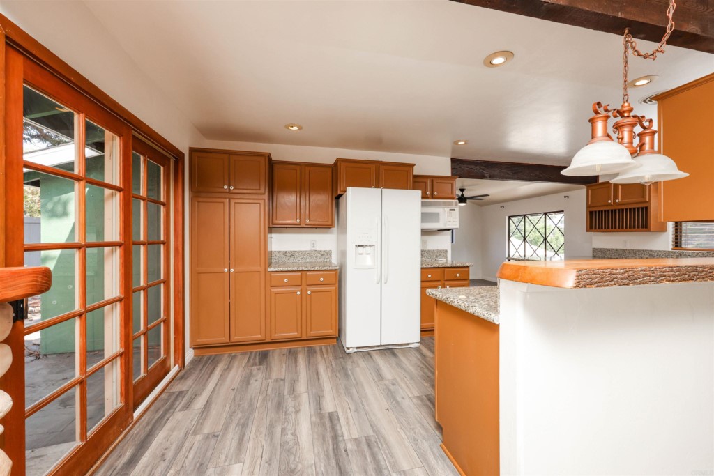 2513 Sarbonne Drive Oceanside, CA 92054 - Photo 26 of 55 a kitchen with stainless steel appliances granite countertop a refrigerator a stove and a wooden floors