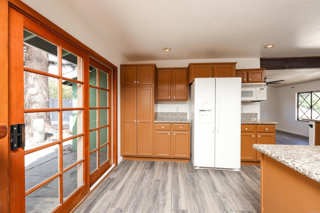 2513 Sarbonne Drive Oceanside, CA 92054 - Photo 27 of 55 a kitchen with stainless steel appliances granite countertop a refrigerator and a stove top oven