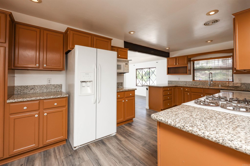 2513 Sarbonne Drive Oceanside, CA 92054 - Photo 28 of 55 a kitchen with a refrigerator sink and cabinets