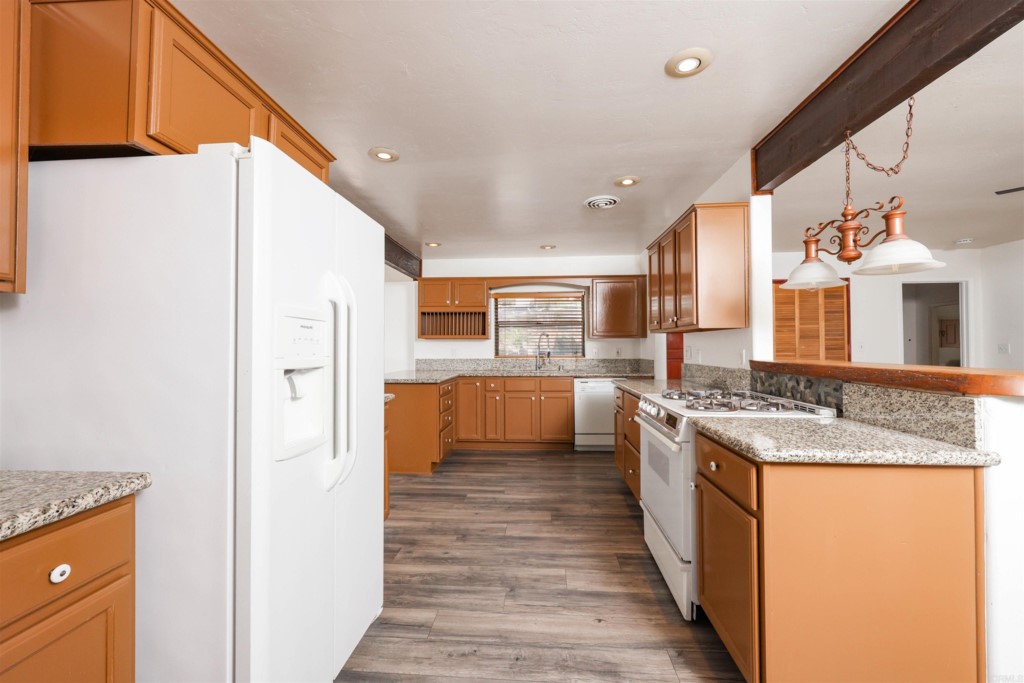 2513 Sarbonne Drive Oceanside, CA 92054 - Photo 29 of 55 a kitchen with stainless steel appliances granite countertop a stove and a refrigerator