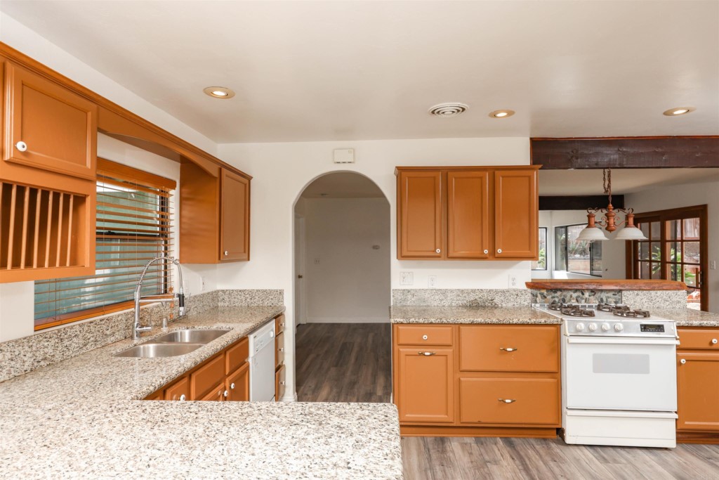 2513 Sarbonne Drive Oceanside, CA 92054 - Photo 32 of 55 a kitchen with granite countertop a sink and a stove
