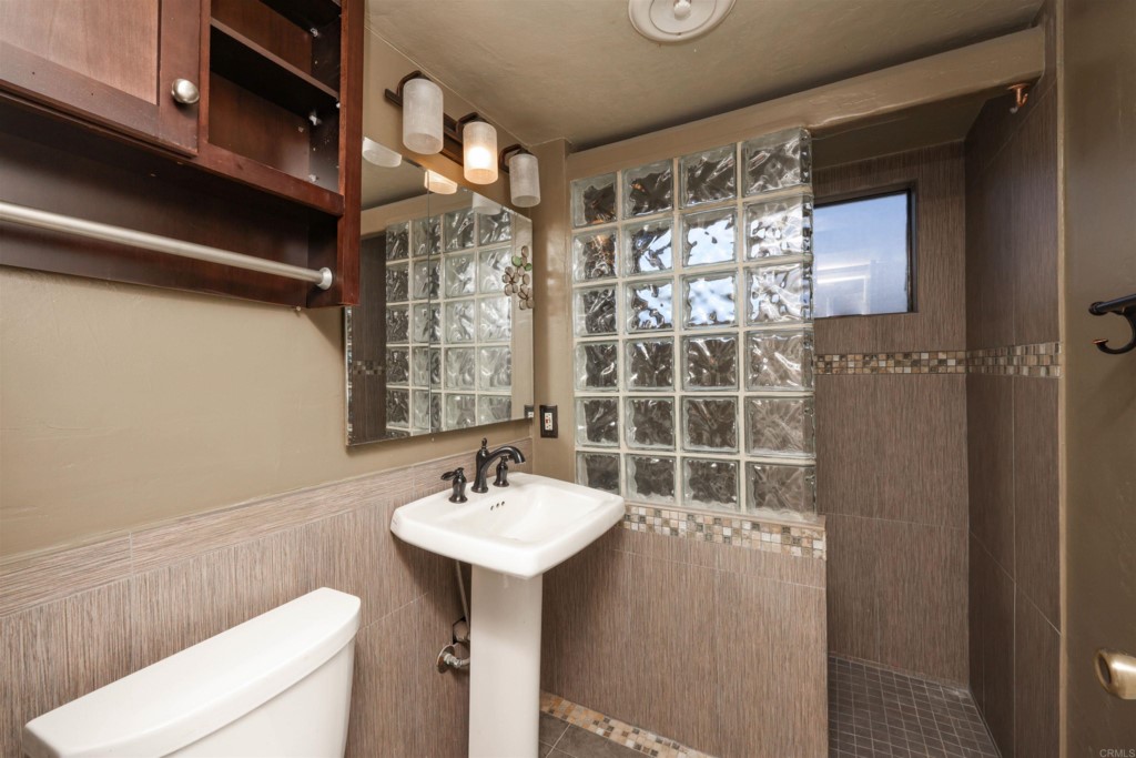 2513 Sarbonne Drive Oceanside, CA 92054 - Photo 35 of 55 a bathroom with a sink a toilet and shower