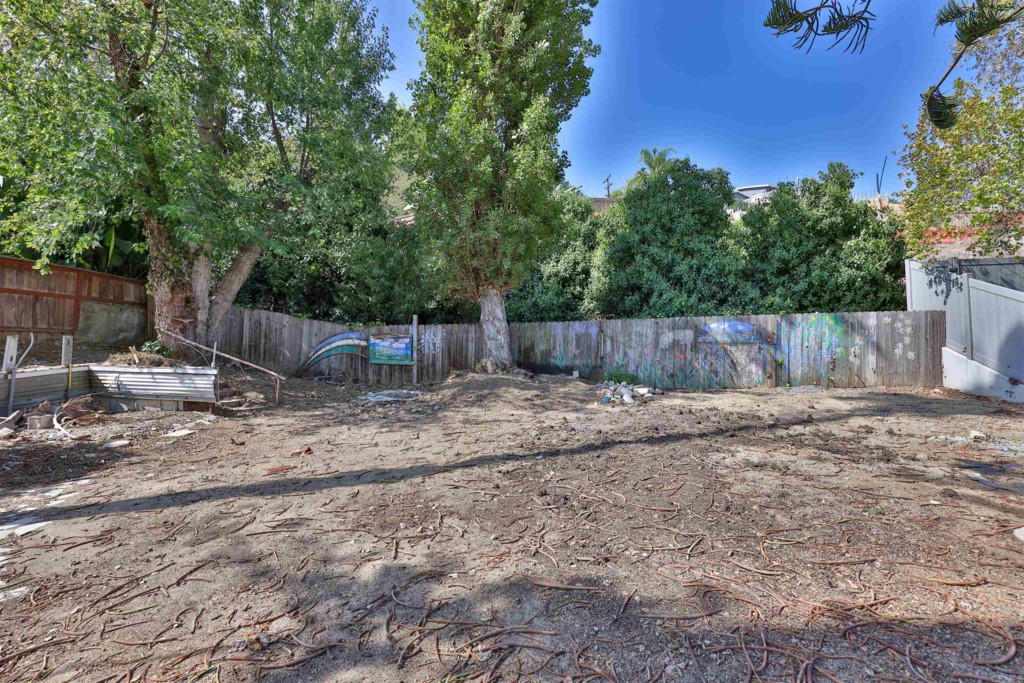 2513 Sarbonne Drive Oceanside, CA 92054 - Photo 42 of 55 a view of a backyard with large tree and wooden fence