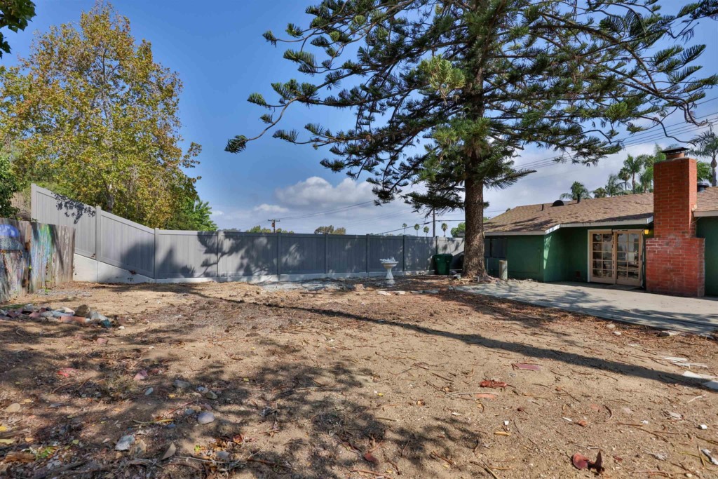 2513 Sarbonne Drive Oceanside, CA 92054 - Photo 49 of 55 a tree is standing in front of a house