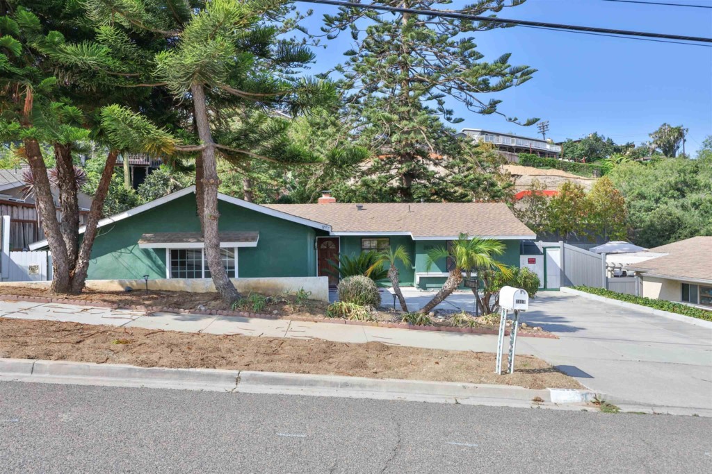 2513 Sarbonne Drive Oceanside, CA 92054 - Photo 6 of 55 a backyard of a house with table and chairs under an umbrella
