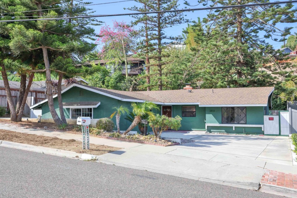 2513 Sarbonne Drive Oceanside, CA 92054 - Photo 8 of 55 a front view of a house with a yard and trees