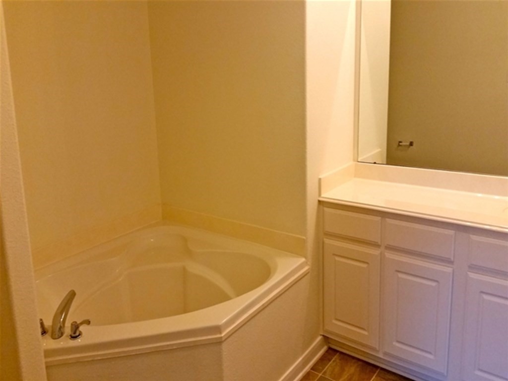 4345 Medina River Loop Spring, TX 77386 - Photo 11 of 14 a bathroom with a bathtub