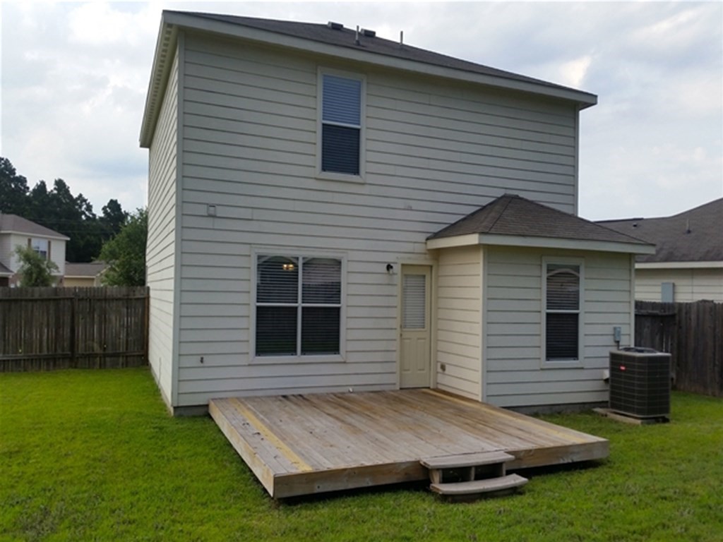 4345 Medina River Loop Spring, TX 77386 - Photo 14 of 14 a view of backyard with a barbeque grill and plants