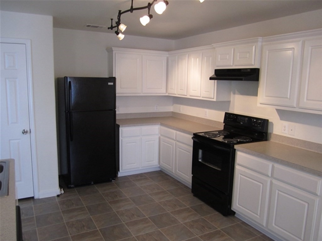 4345 Medina River Loop Spring, TX 77386 - Photo 2 of 14 a kitchen with a sink and a refrigerator
