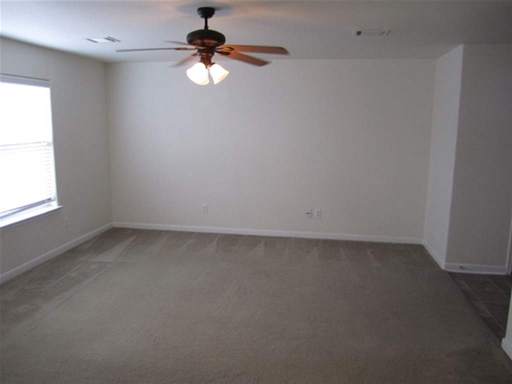 4345 Medina River Loop Spring, TX 77386 - Photo 8 of 14 an empty room with a window and a fan