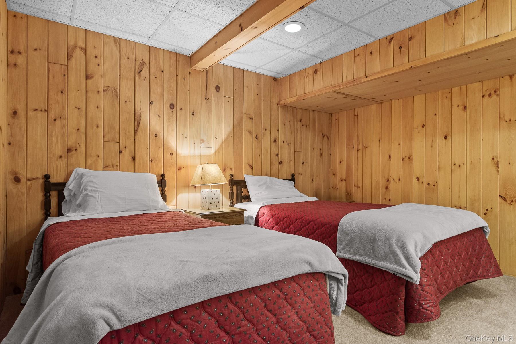 1009 Beaverkill Road Livingston Manor, NY 12758 - Photo 18 of 19 a bedroom with two beds and a chandelier