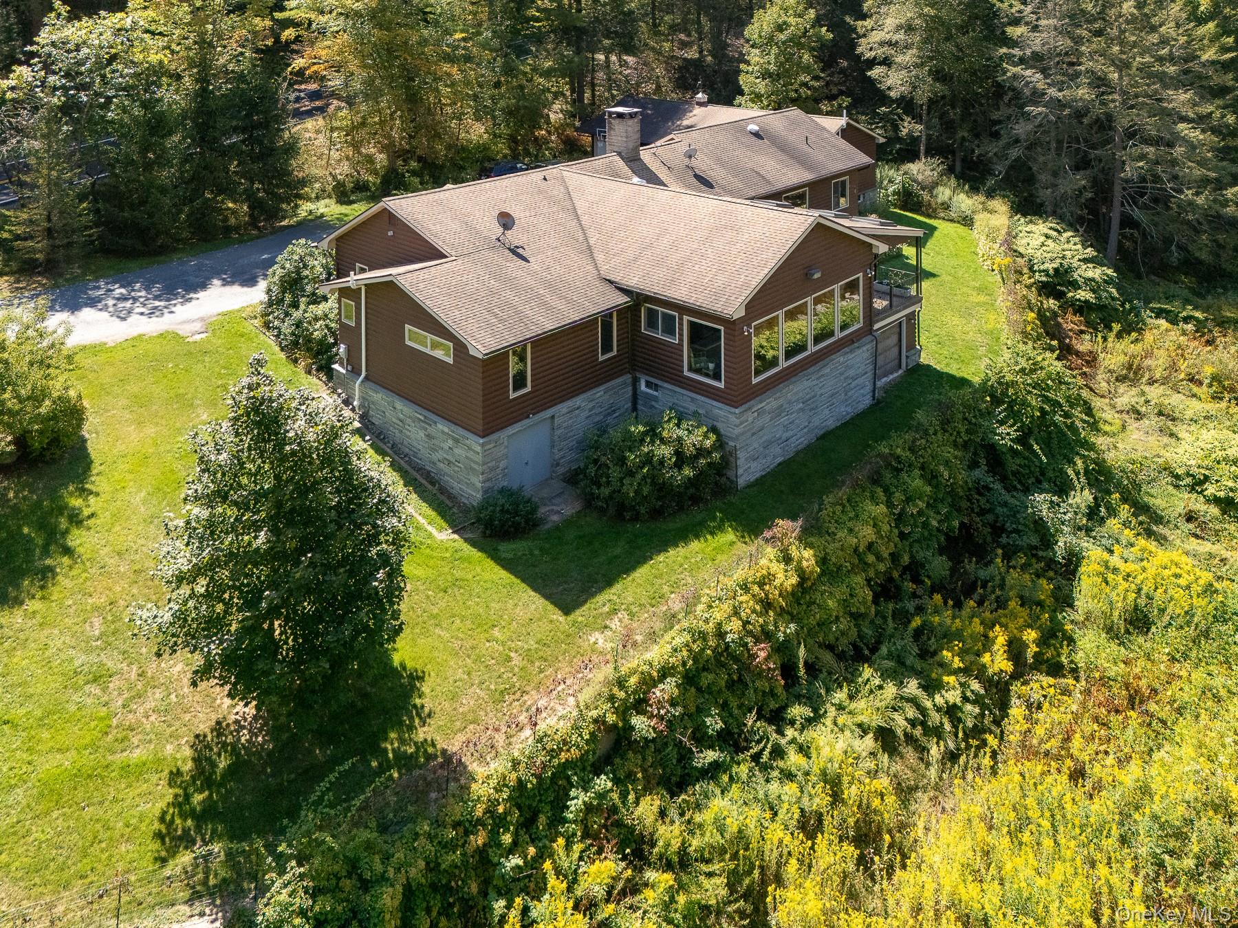 1009 Beaverkill Road Livingston Manor, NY 12758 - Photo 2 of 19 an aerial view of a house with a yard swimming pool and outdoor seating