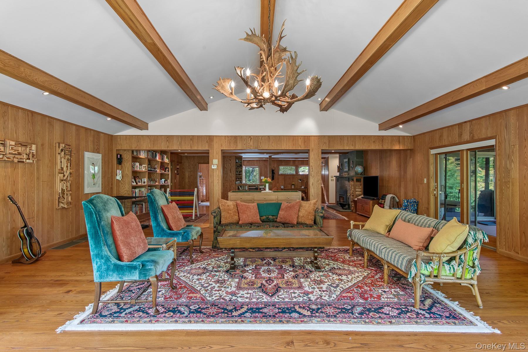 1009 Beaverkill Road Livingston Manor, NY 12758 - Photo 7 of 19 a living room with furniture a rug and a chandelier